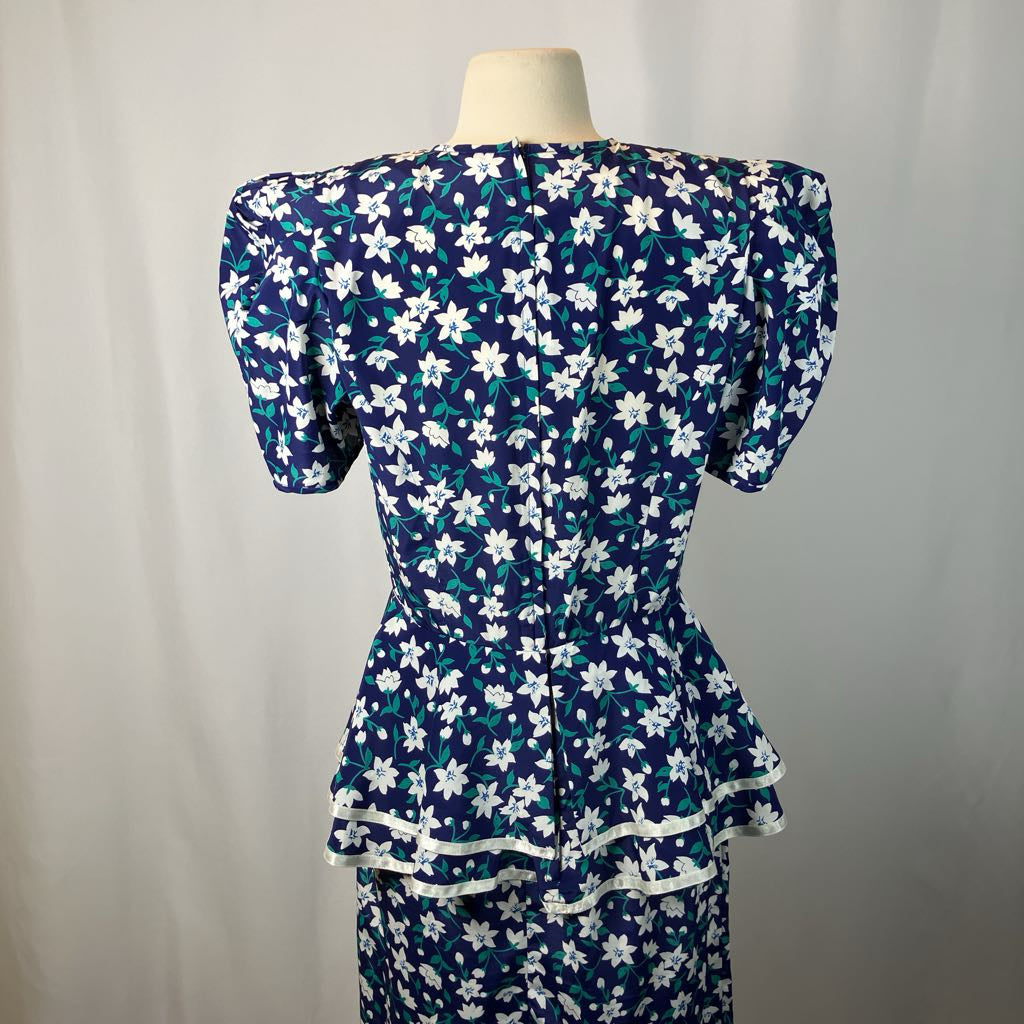 Navy blue dress with white floral pattern on a mannequin against a plain background