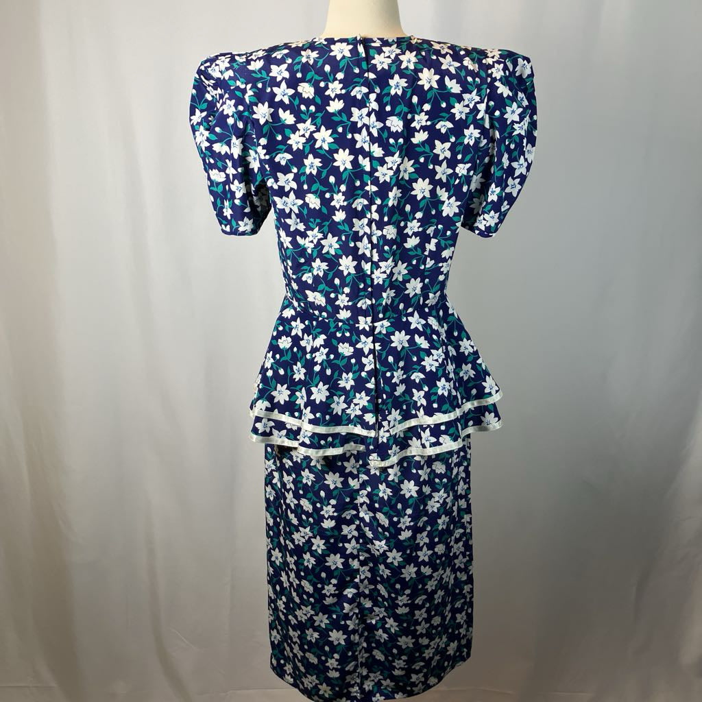 Navy blue dress with white floral pattern on a mannequin against a plain background