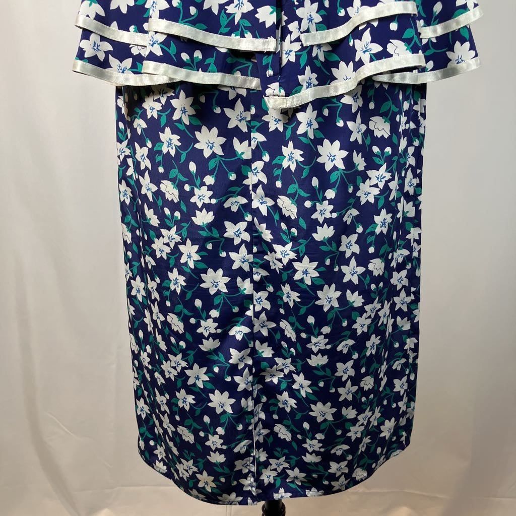 Navy blue dress with white floral pattern on a mannequin against a plain background