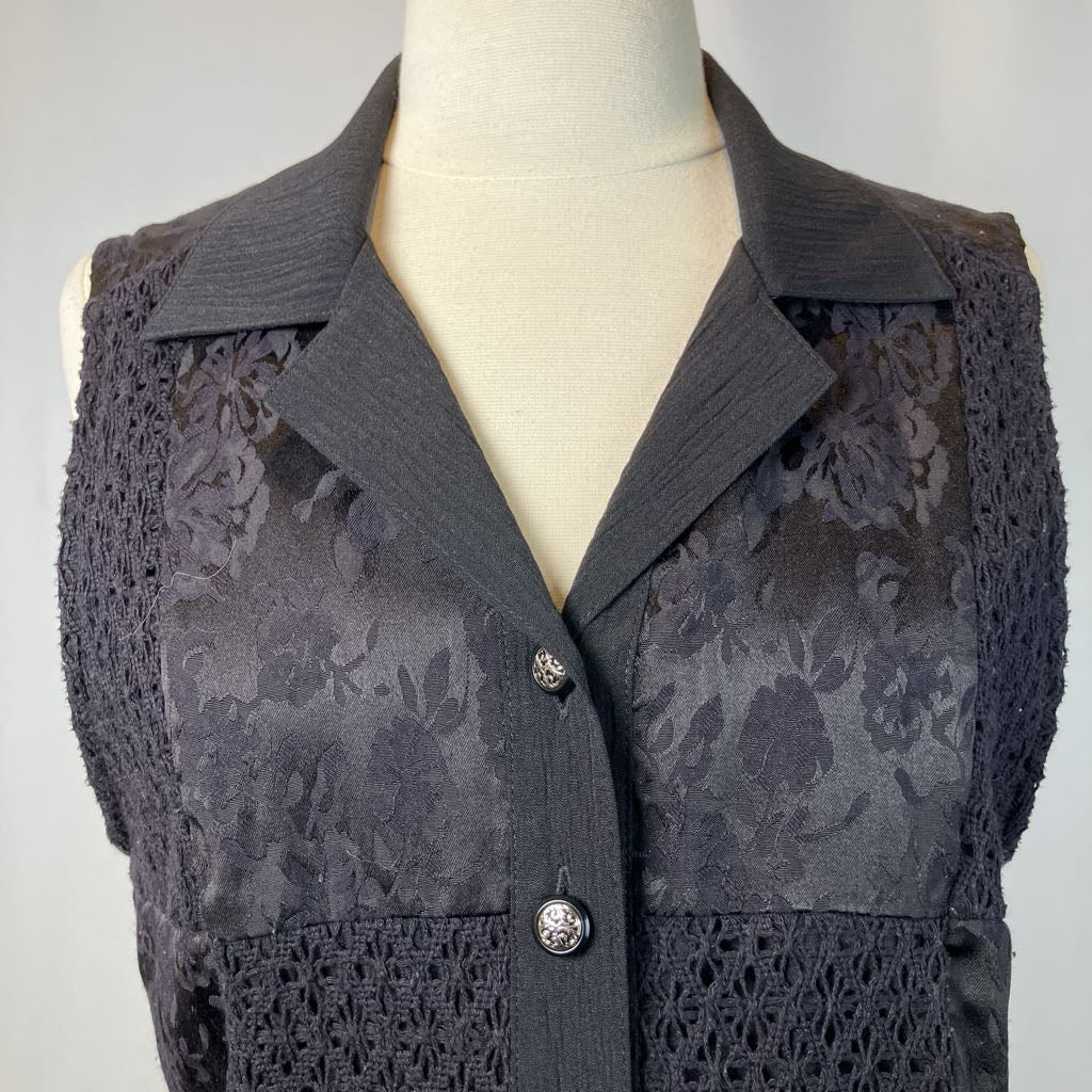 Black vest on a mannequin against a gray background