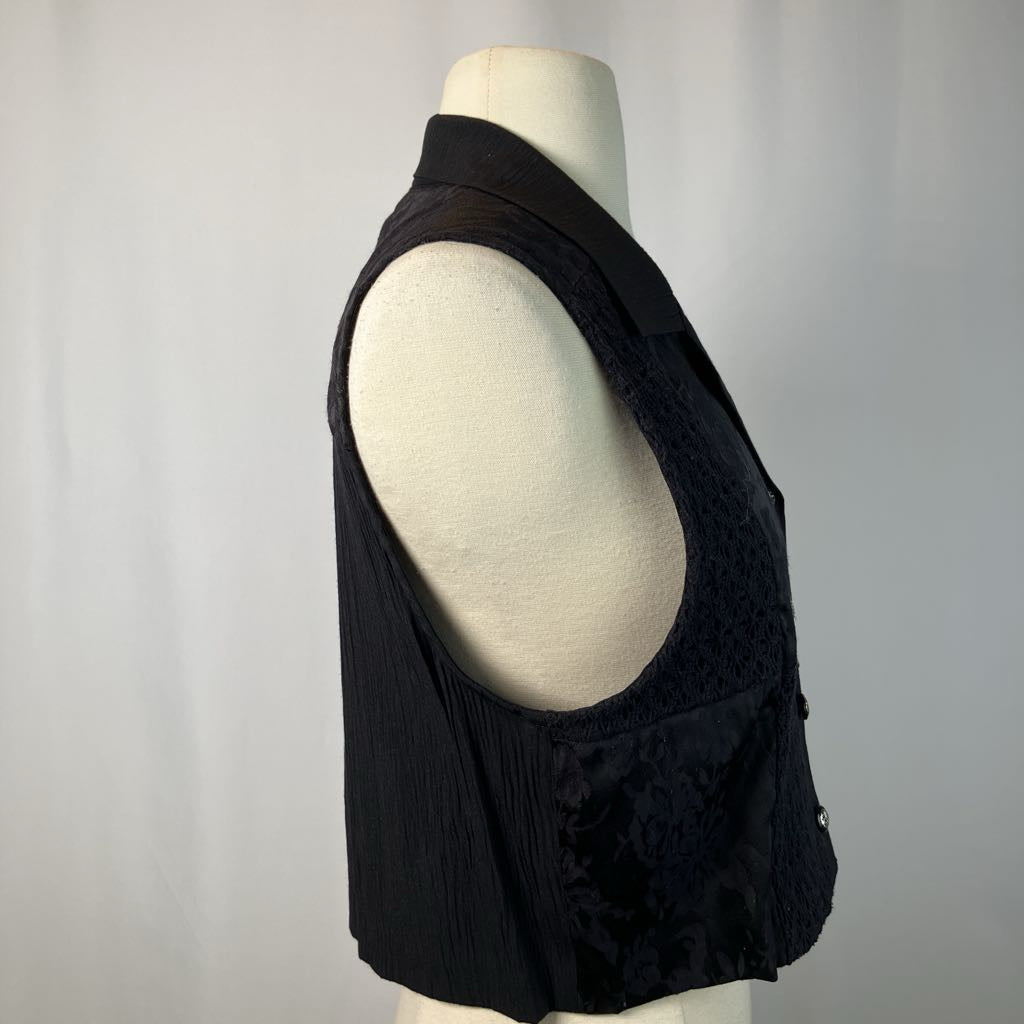 Black sleeveless top on a mannequin against a plain background