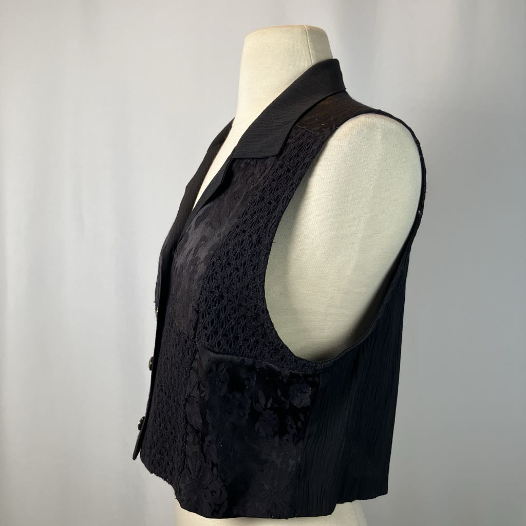 Black vest on a mannequin against a gray background