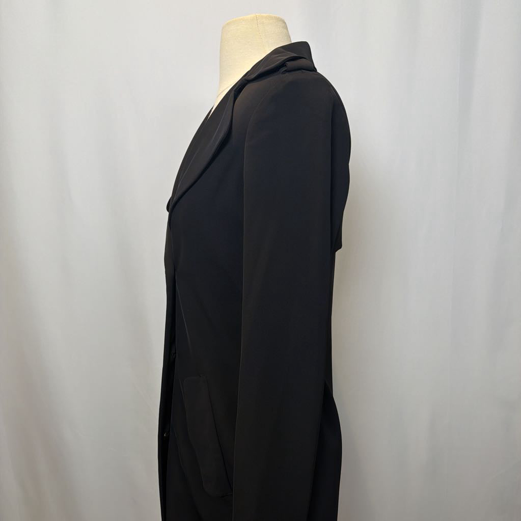 Black coat dress on a mannequin against a plain background