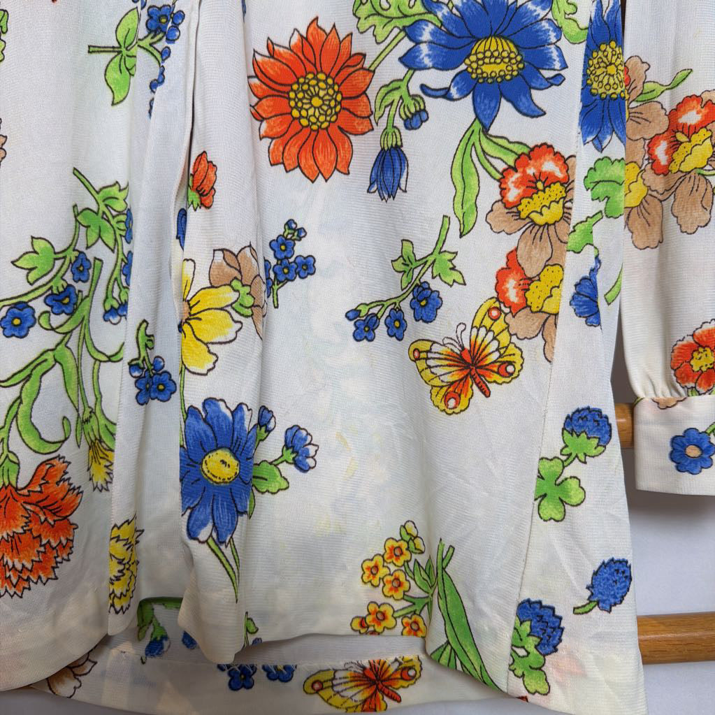 Floral and butterfly patterned fabric with colorful flowers on a white background