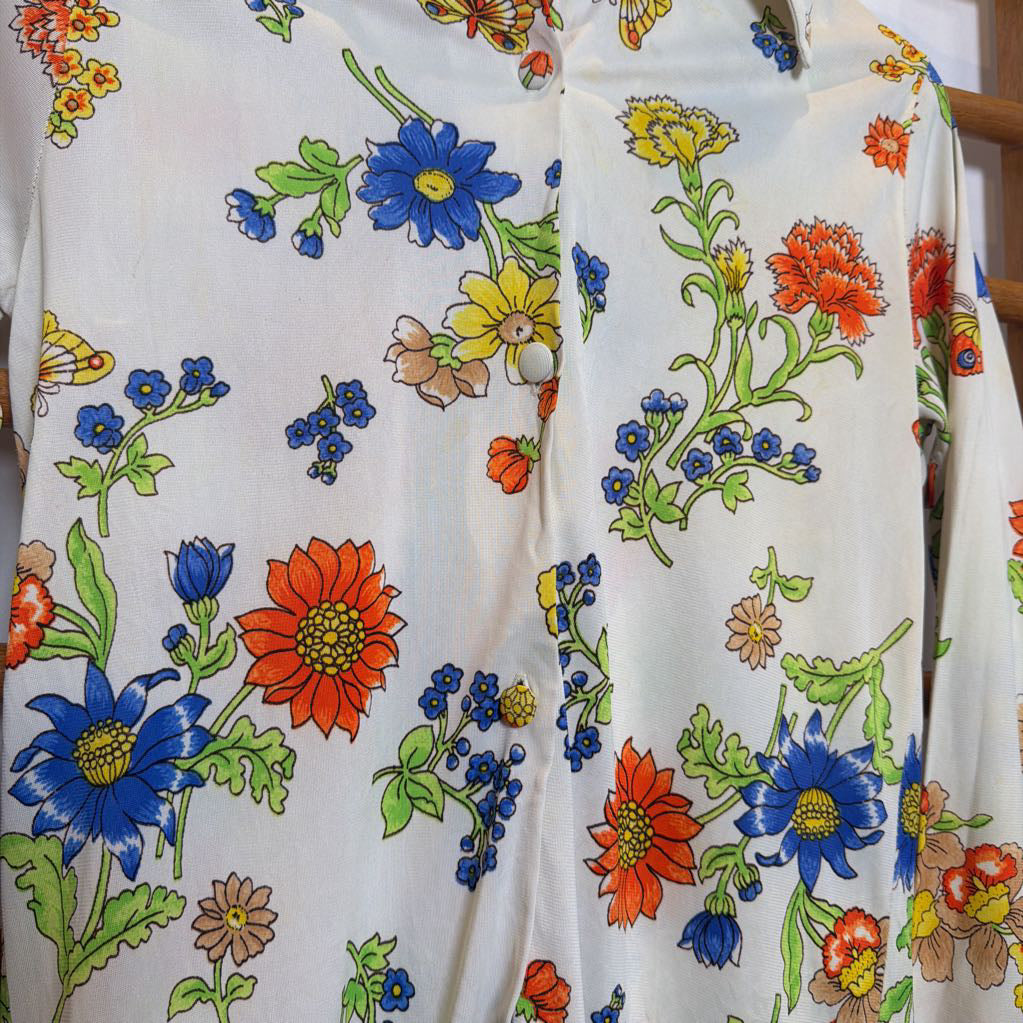 White shirt with colorful floral pattern on a wooden hanger