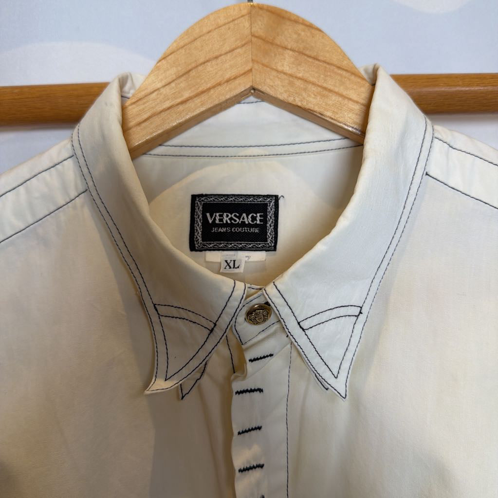White shirt with Versace label on a wooden hanger