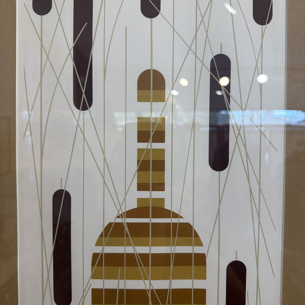Decorative glass panel with abstract brown and black design on a beige background
