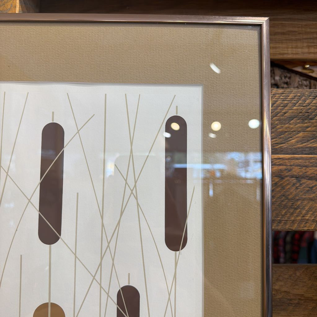 Framed abstract artwork with geometric design on a neutral background