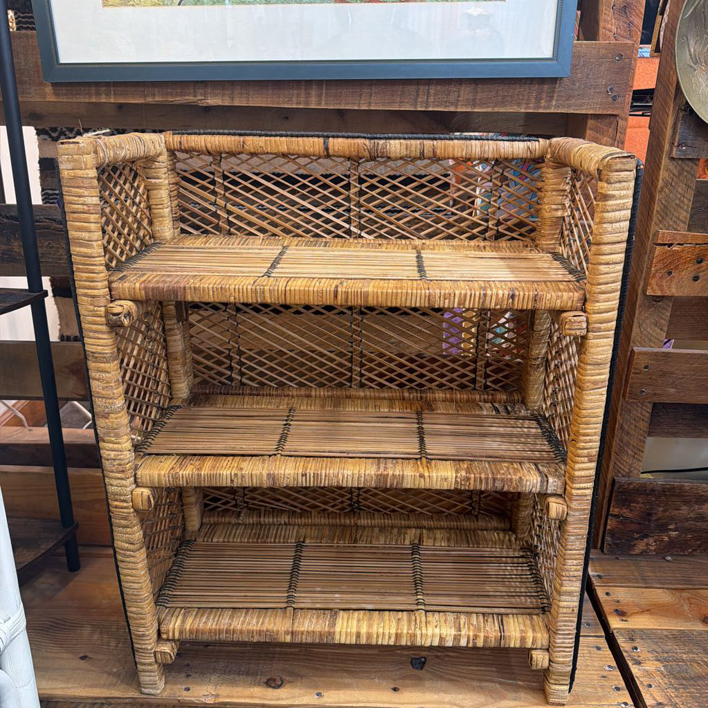 Wicker bookshelf with lattice design on a wooden floor