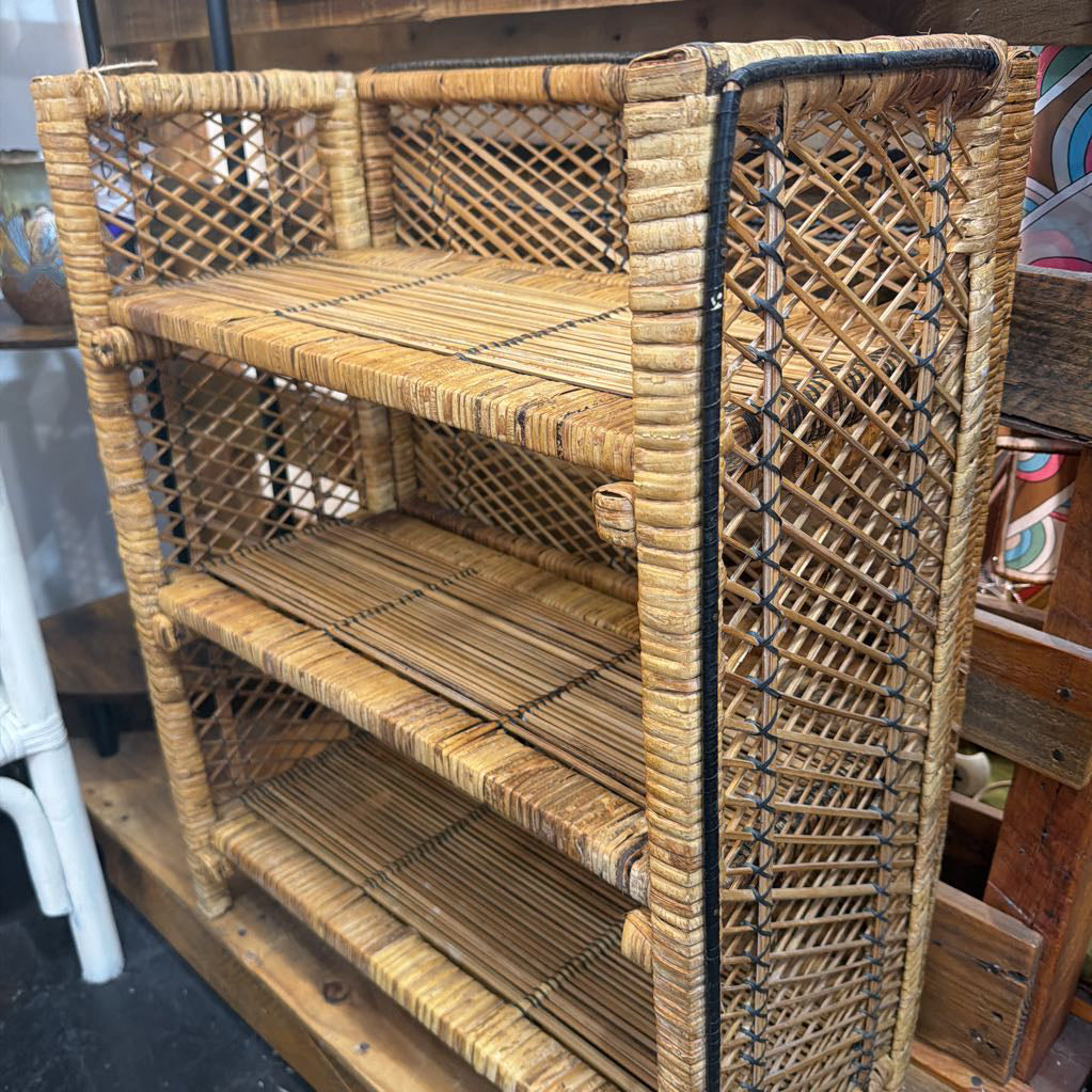 Wicker shelf with three shelves in a room setting