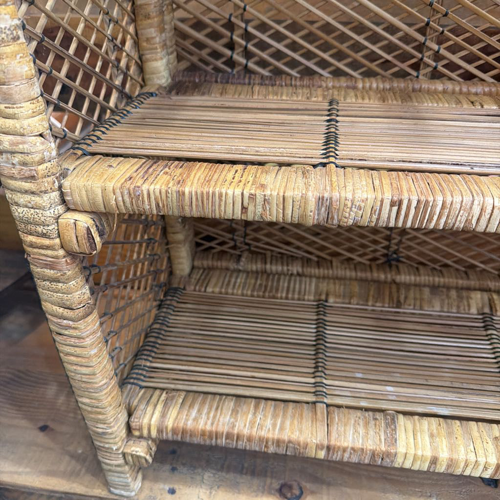 Wicker chair with a lattice back and seat on a wooden floor.