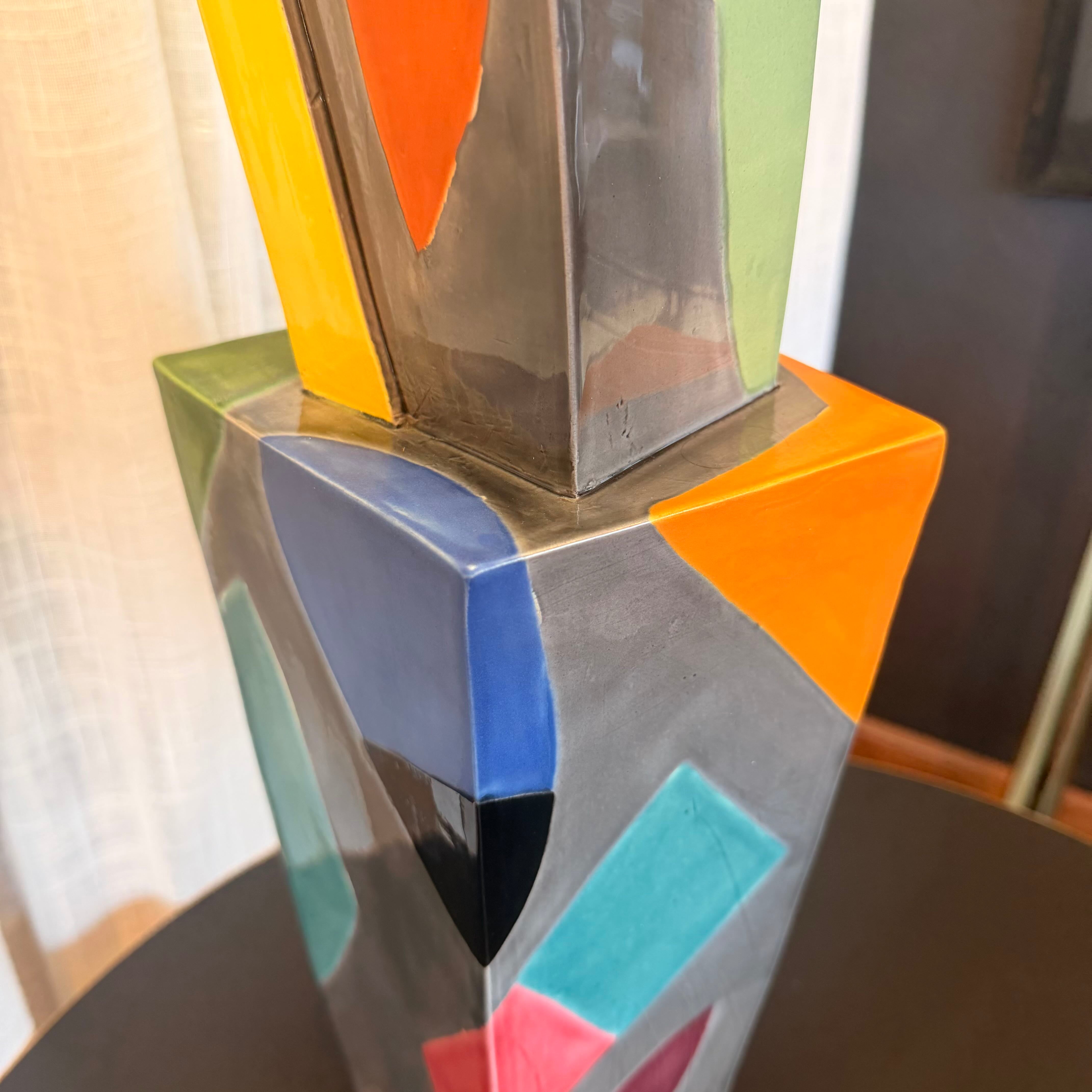 Colorful geometric sculpture on a dark surface