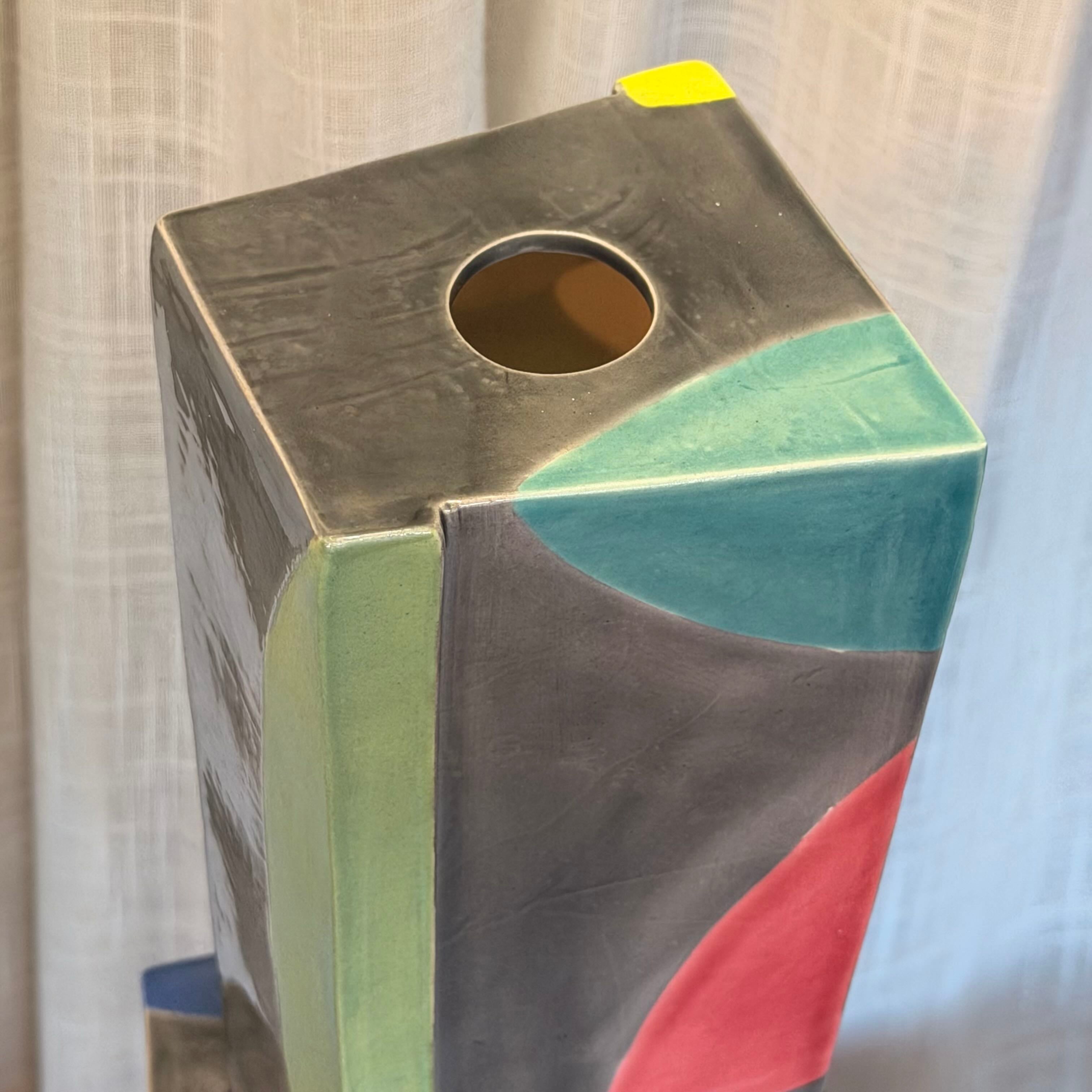 Multicolored rectangular object with a circular opening on a neutral background
