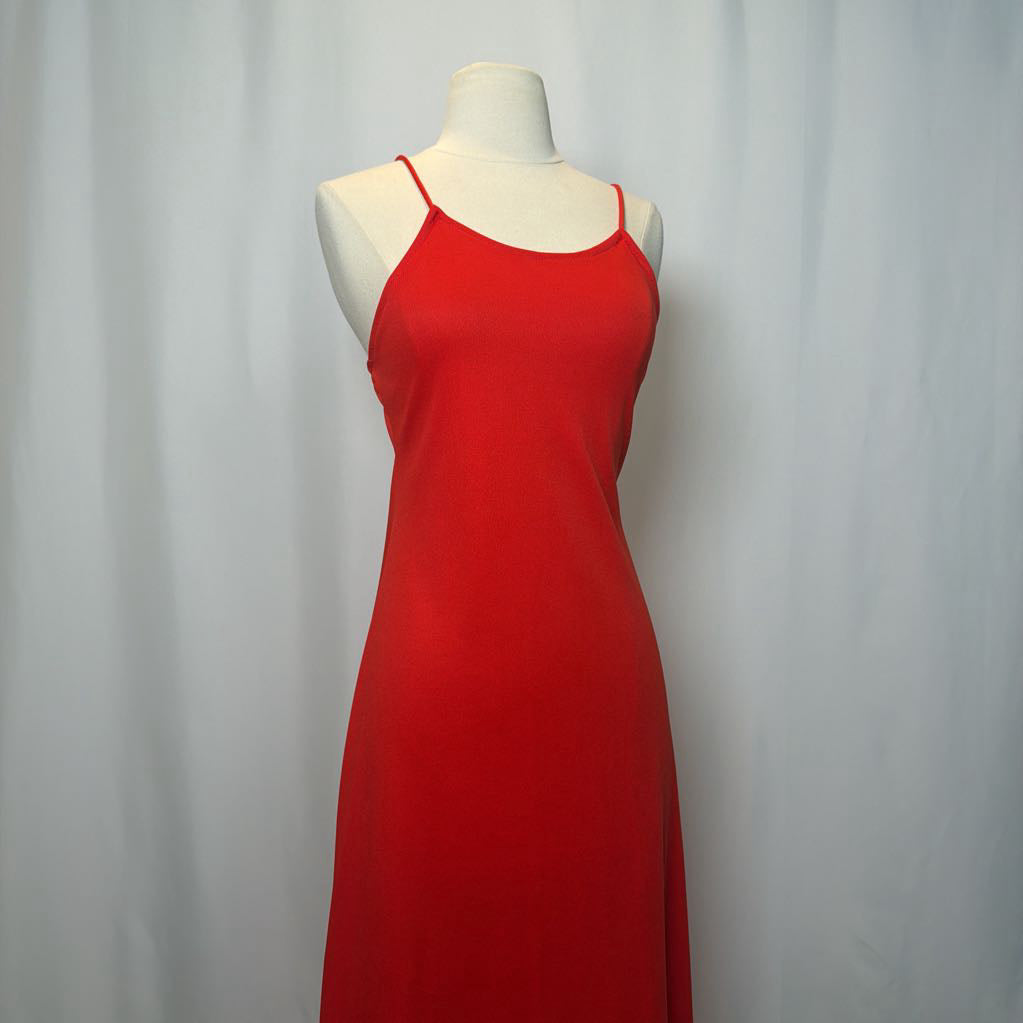 Red dress on a mannequin against a plain background