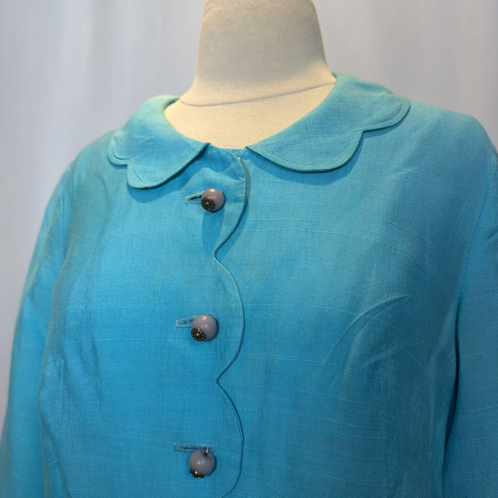 Blue jacket on a mannequin against a plain background