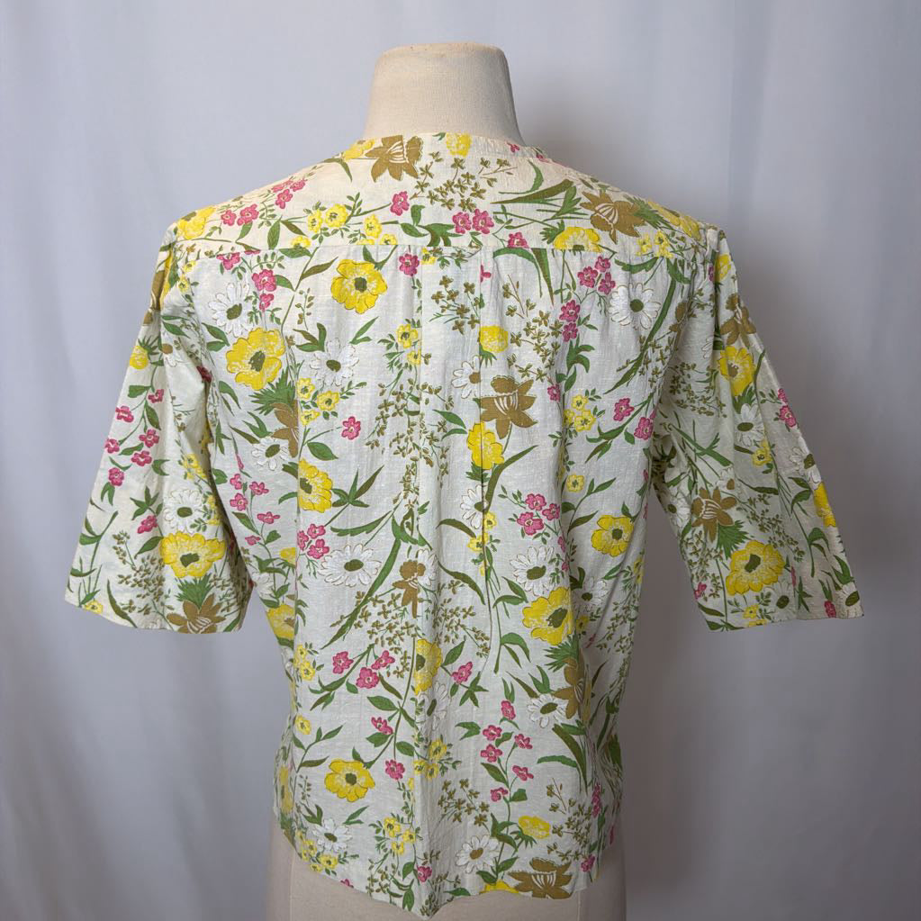 Floral patterned shirt on a mannequin against a plain background