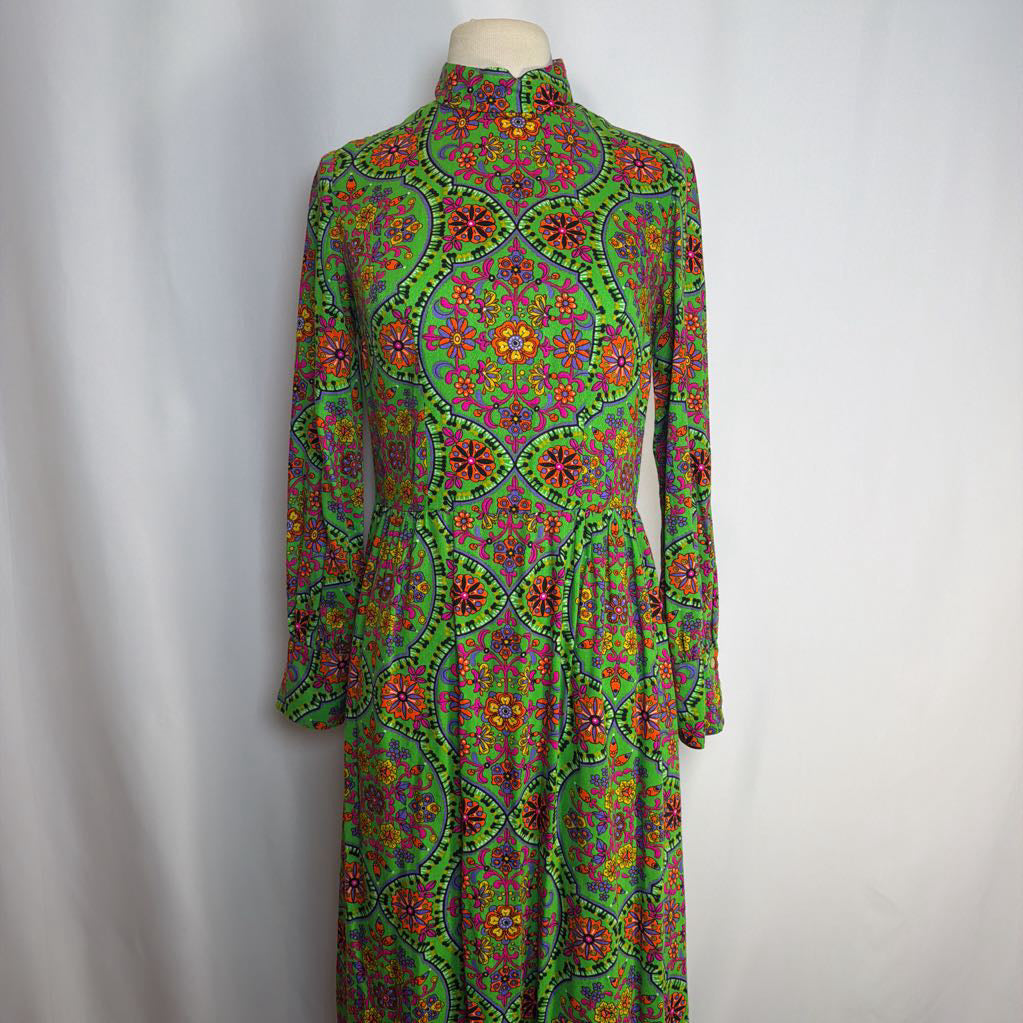 Colorful patterned dress on a mannequin against a plain background