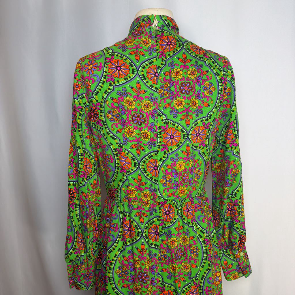 Colorful patterned shirt on a mannequin against a plain background