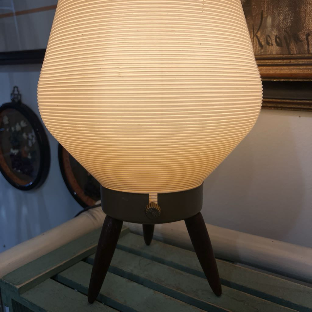 Vintage-style lamp with a ribbed shade on a wooden surface