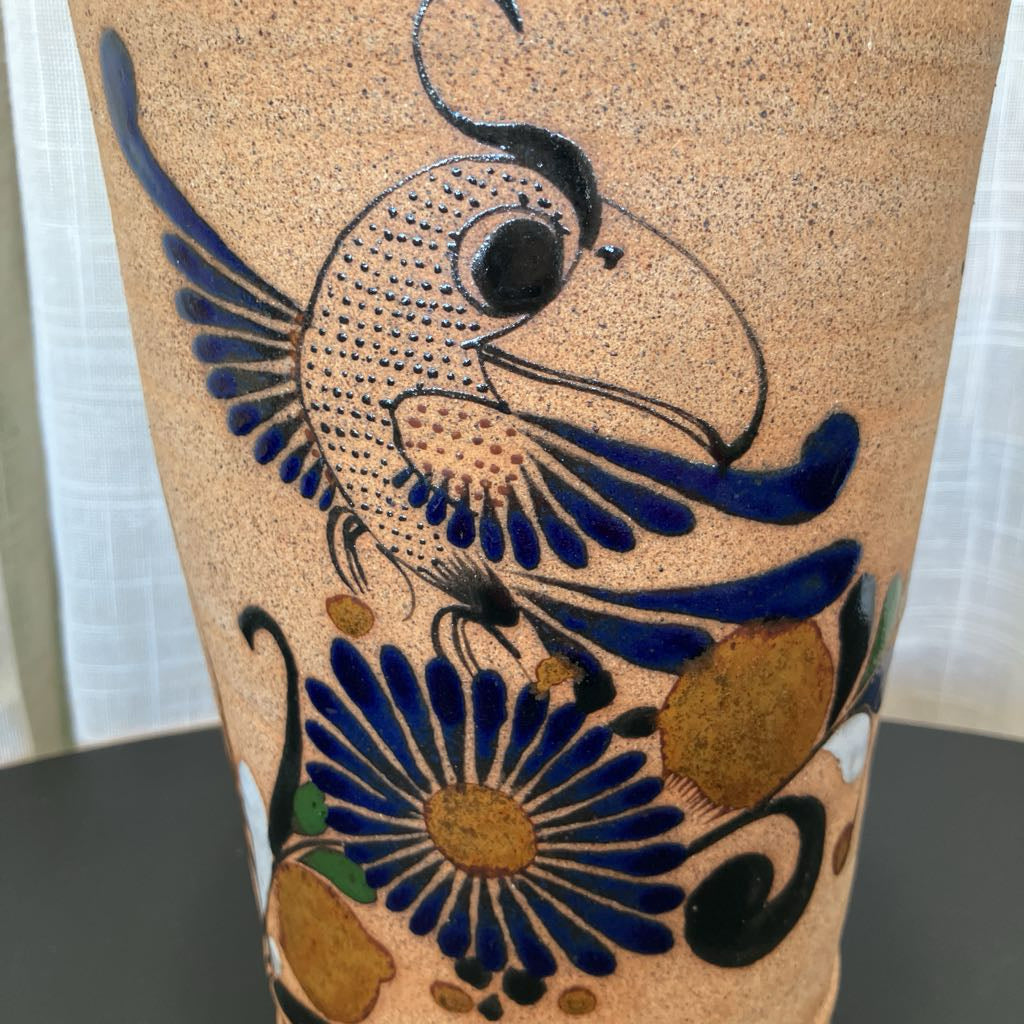 Pottery with blue and black floral design on a neutral background
