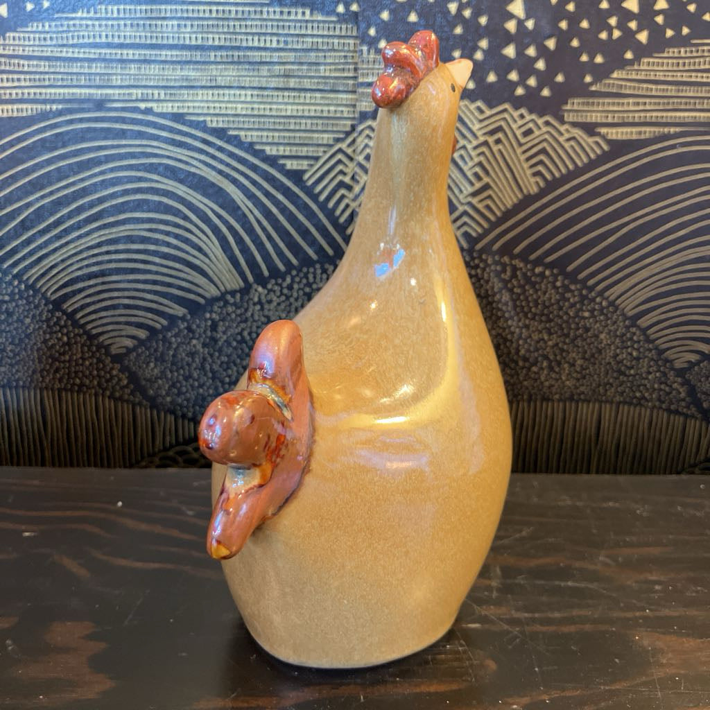 Ceramic chicken on a textured surface