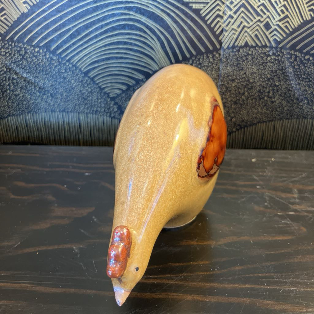 Decorative ceramic object with a textured surface on a dark surface