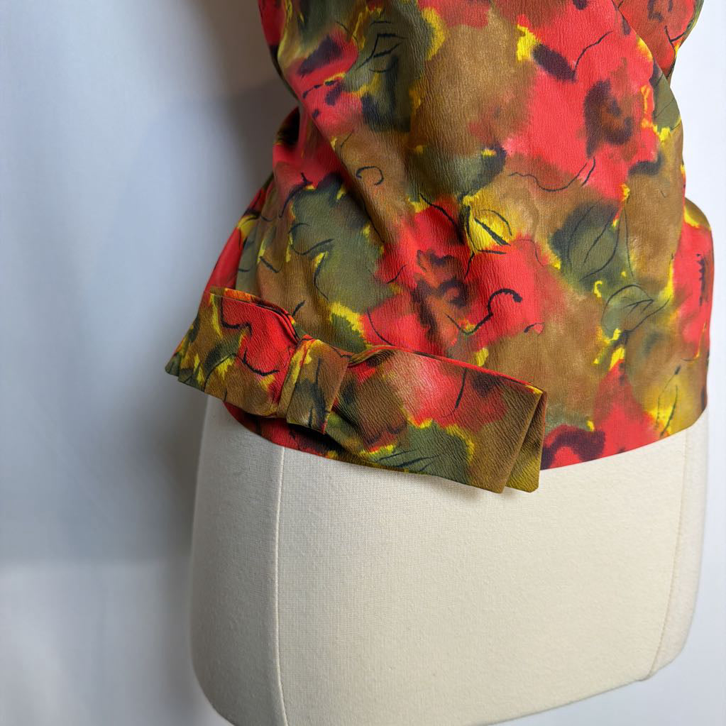 Colorful floral-patterned top on a mannequin against a light background