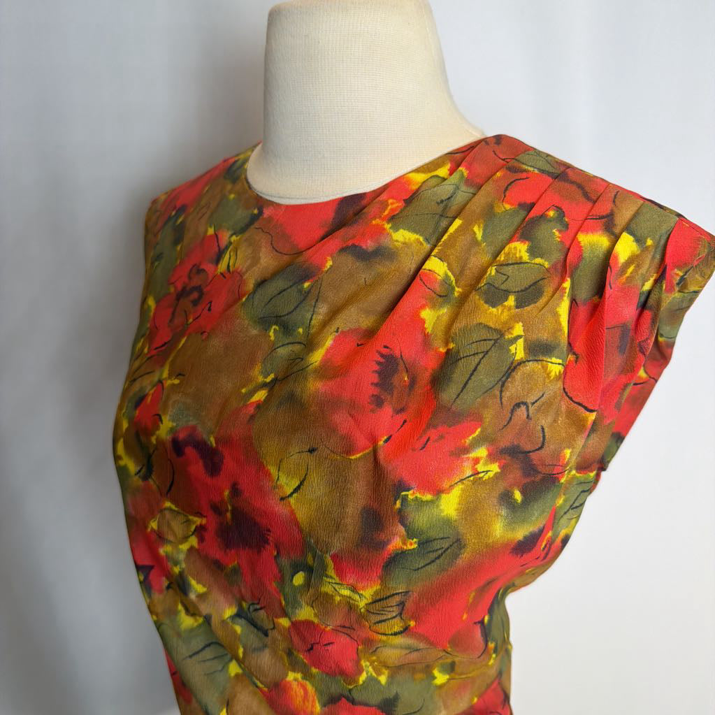 Colorful floral-patterned fabric draped over a mannequin on a white background