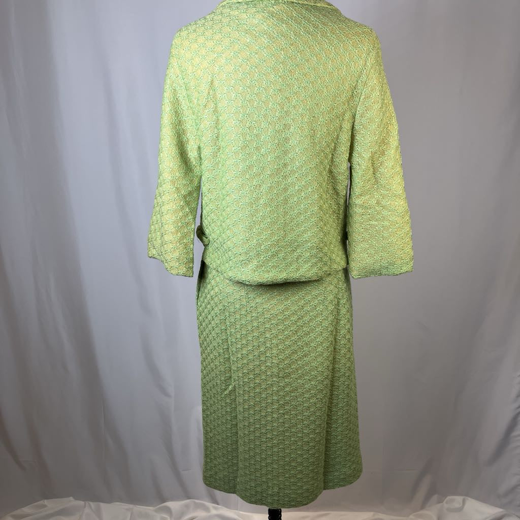 Green textured dress on a mannequin against a plain background