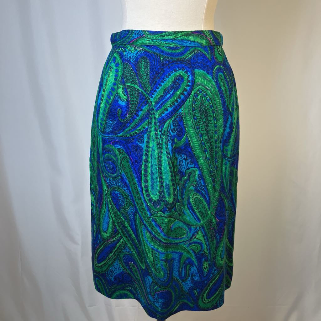 Blue and green patterned skirt on a mannequin against a white background