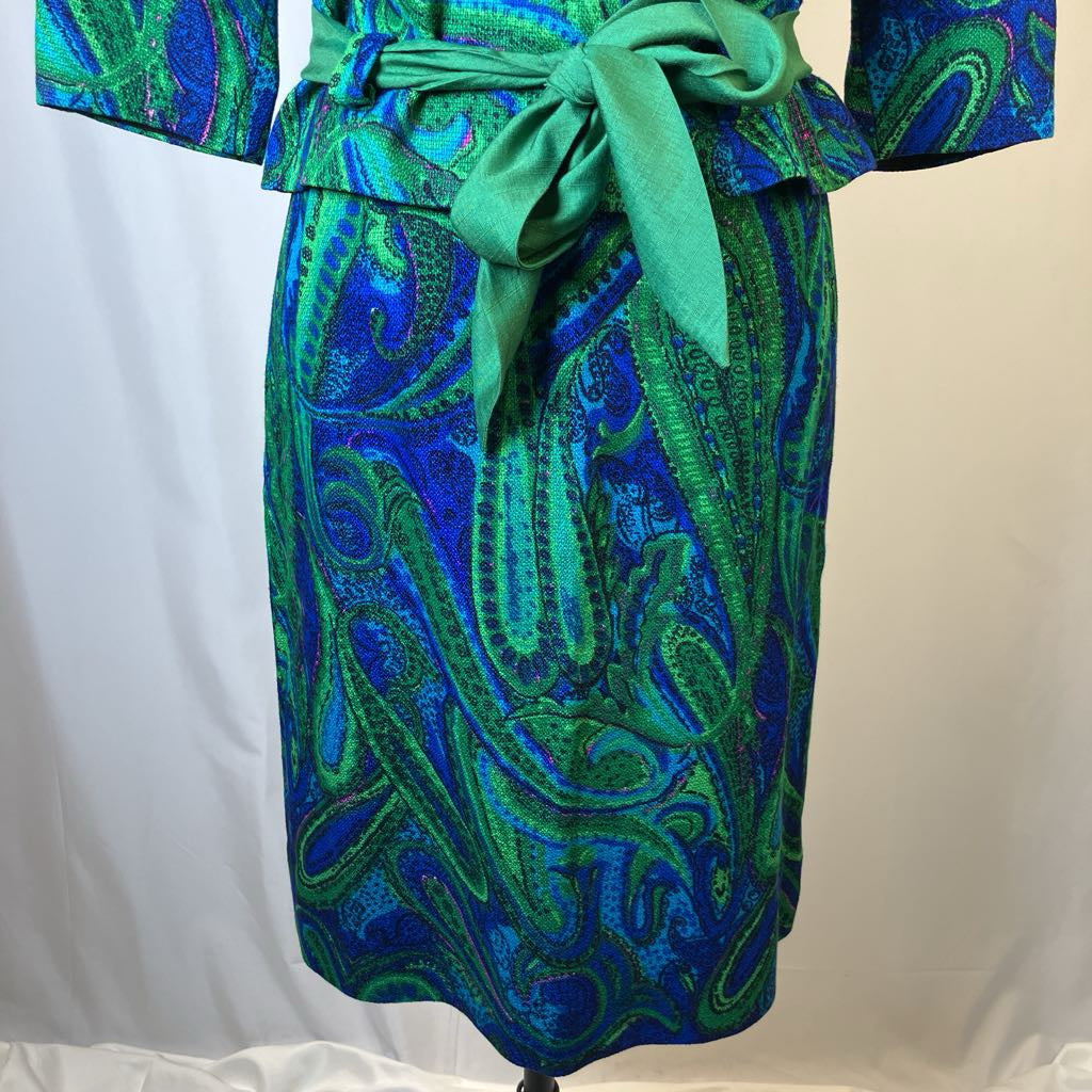 Blue and green patterned dress with a belt on a white background