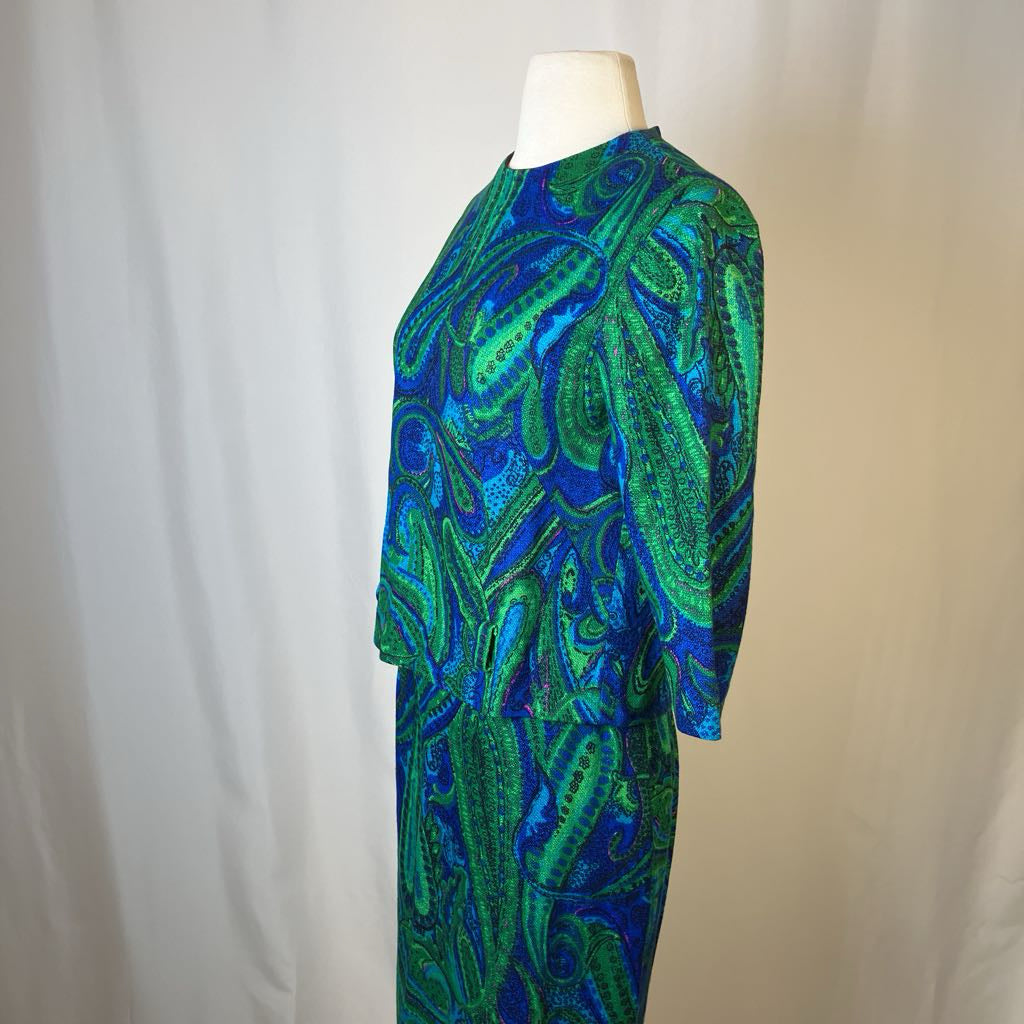 Mannequin wearing a blue and green patterned dress against a plain background
