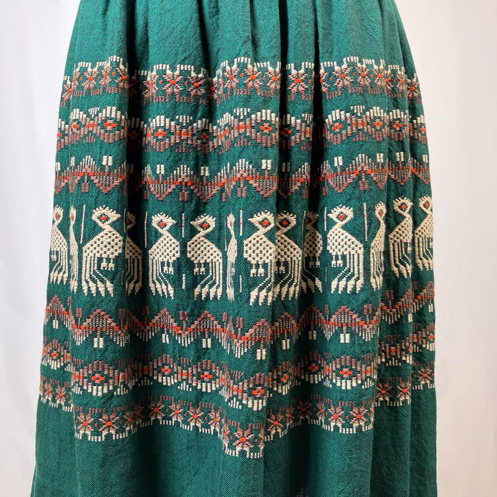 Green skirt with intricate patterns on a white background