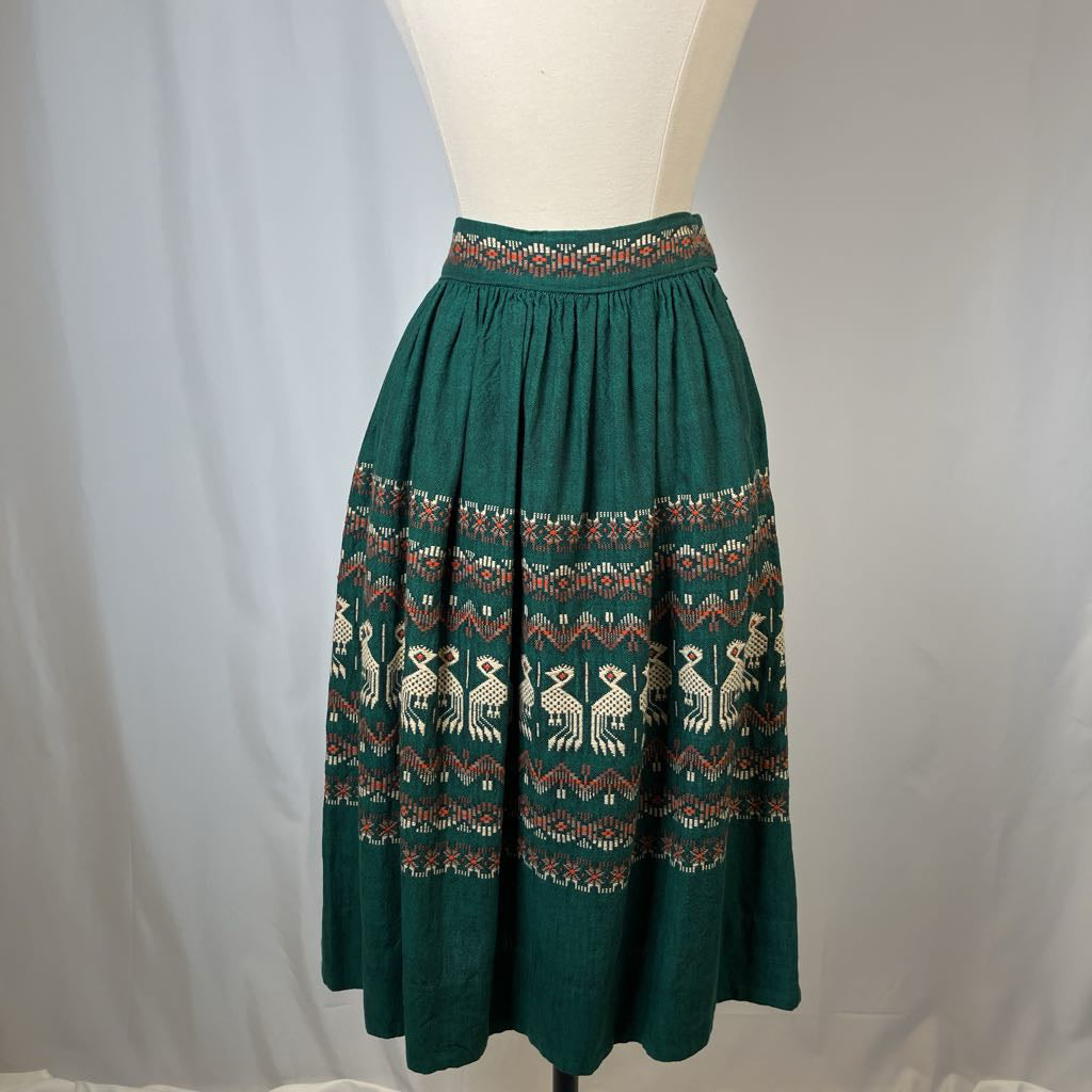 Green skirt with pattern on a mannequin against a plain background