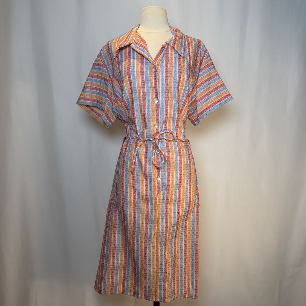 Multicolored striped dress on a mannequin against a plain background