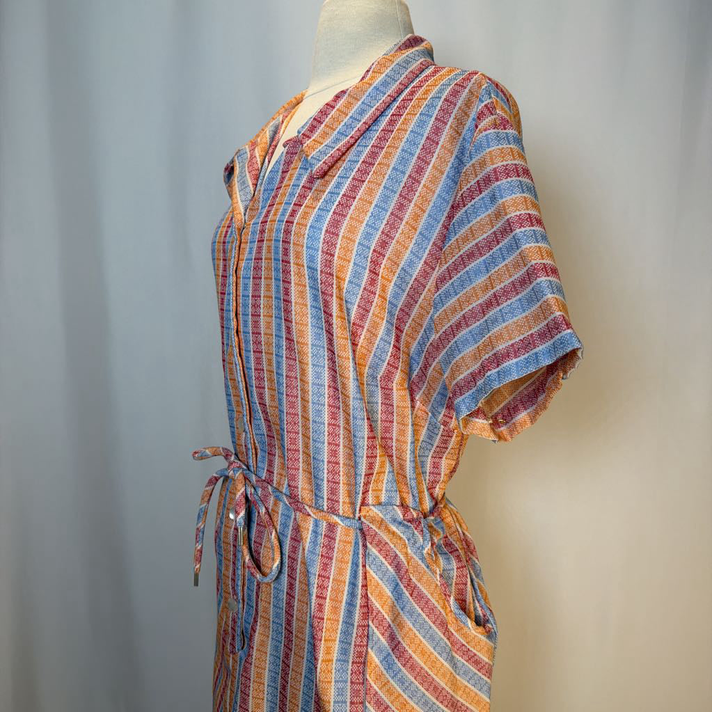 Multicolored striped dress on a mannequin against a plain background