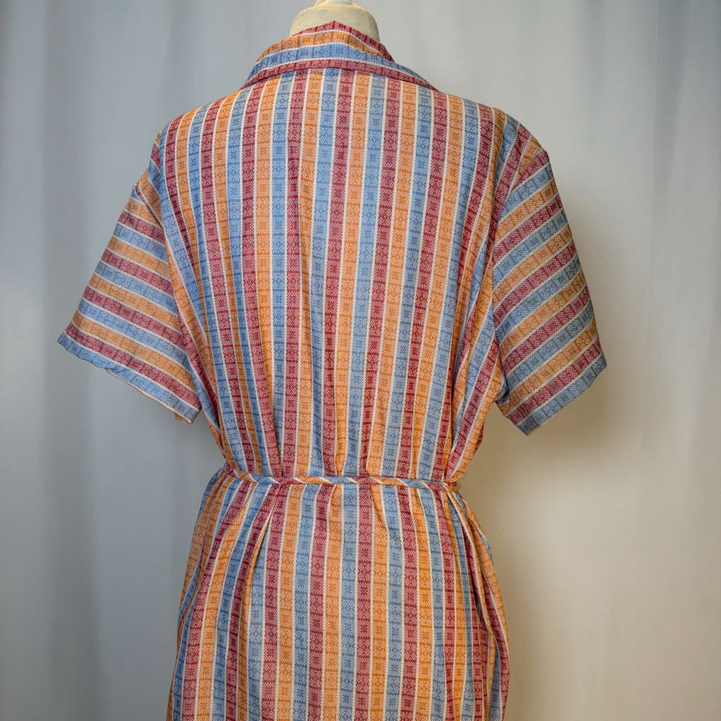Colorful striped dress on a mannequin against a plain background