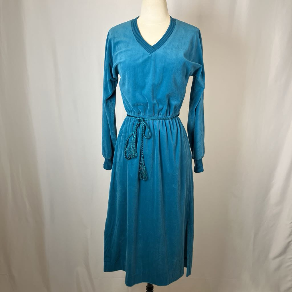 Blue dress on a mannequin against a plain background