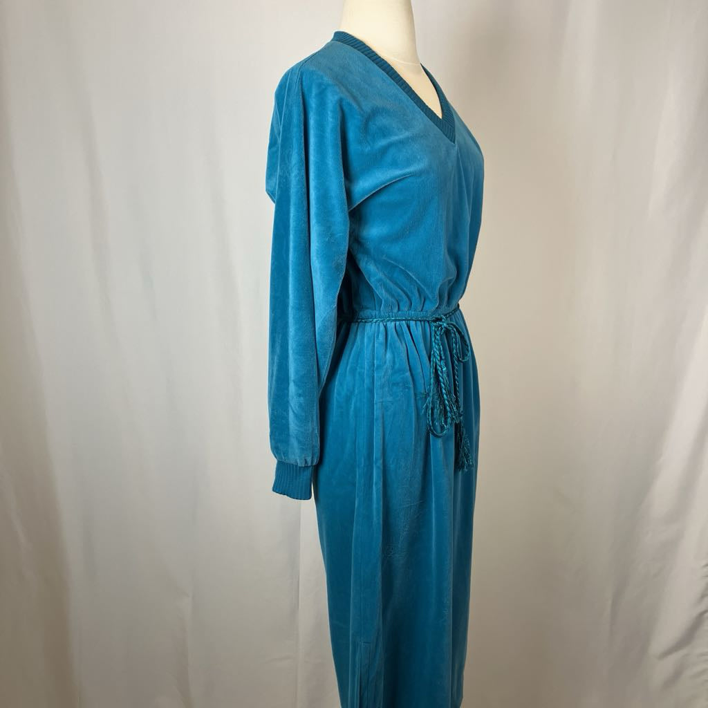 Blue jumpsuit on a mannequin against a plain background