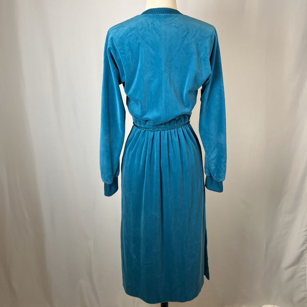 Blue dress on a mannequin against a plain background