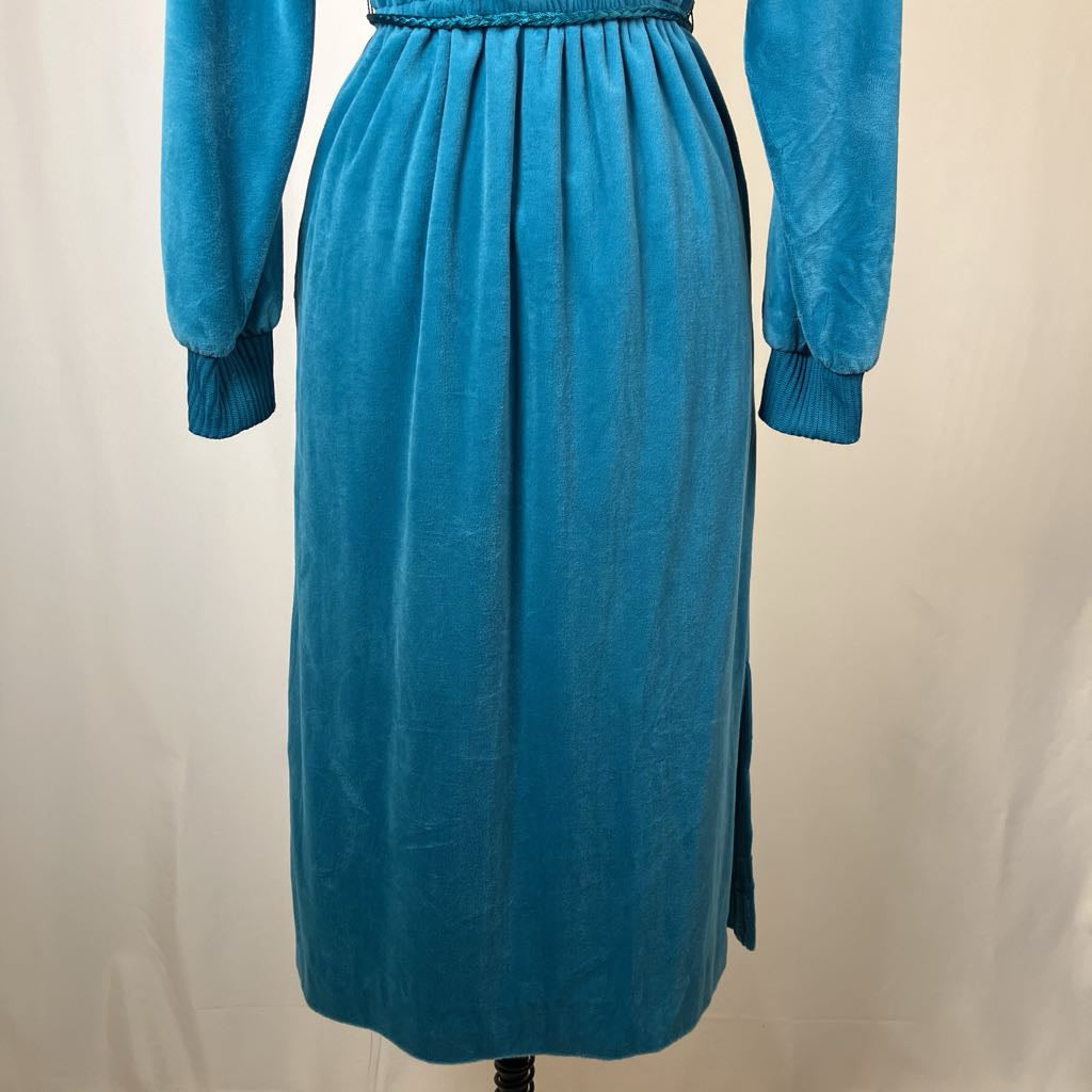 Blue dress on a mannequin against a beige background