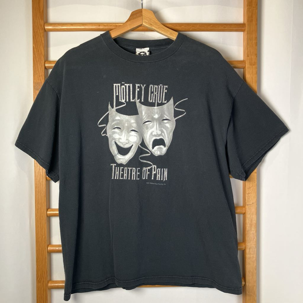 Black t-shirt with Mötley Crüe 'Theatre of Pain' graphic on a wooden hanger.