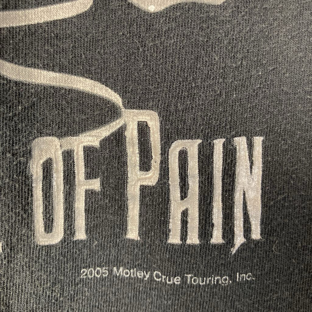Text 'OF PAIN' on a dark background with '2005 Motley Crue Touring, Inc.' below.