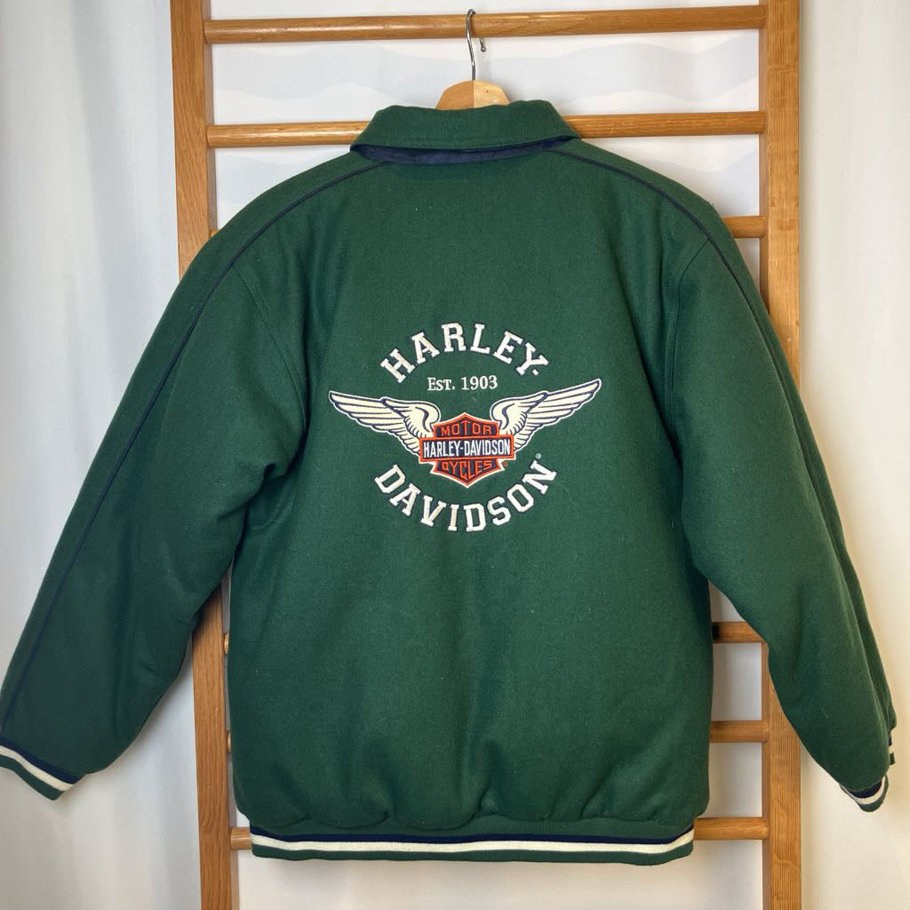Green Harley Davidson jacket on a wooden rack against a white wall