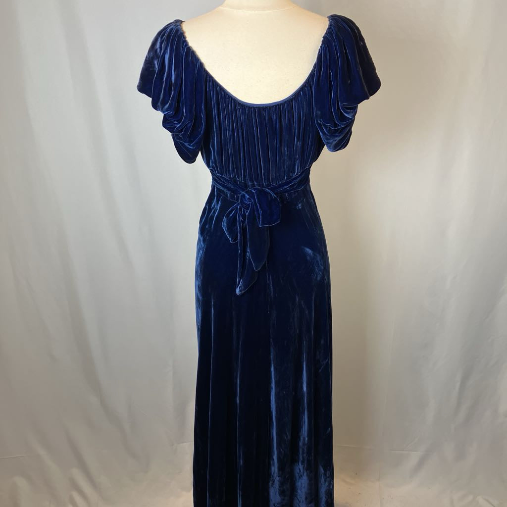Navy blue velvet dress on a mannequin against a plain background