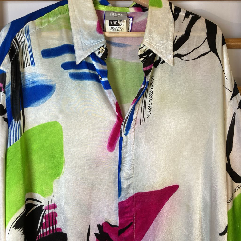 Colorful patterned shirt on a hanger with visible brand label.