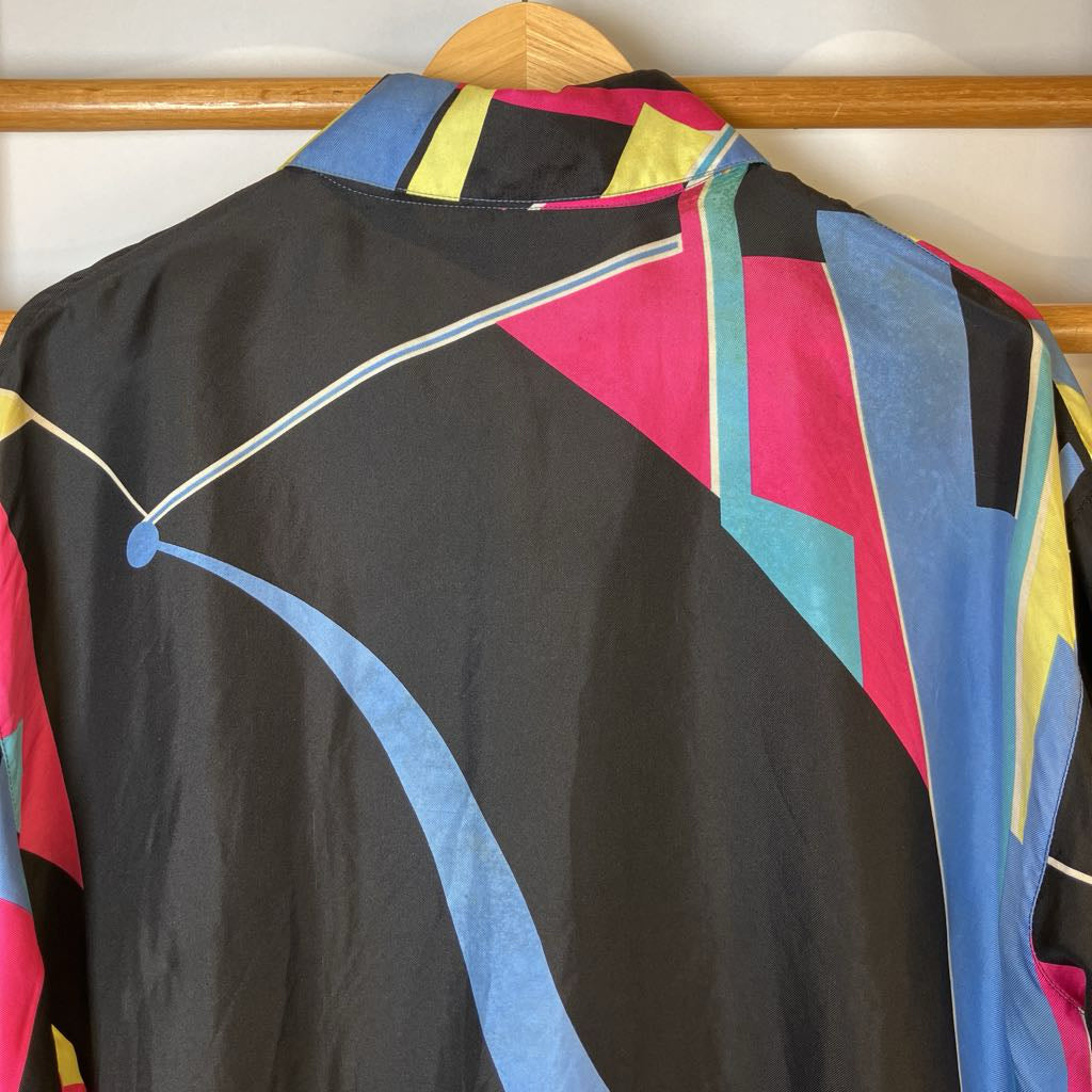 Colorful shirt with geometric patterns on a wooden hanger