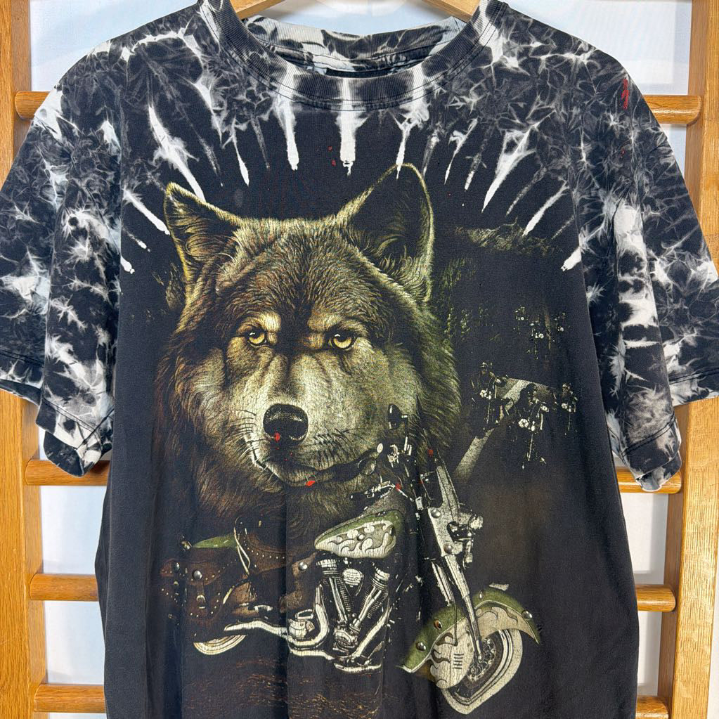 T-shirt with a wolf and motorcycle graphic on a wooden hanger