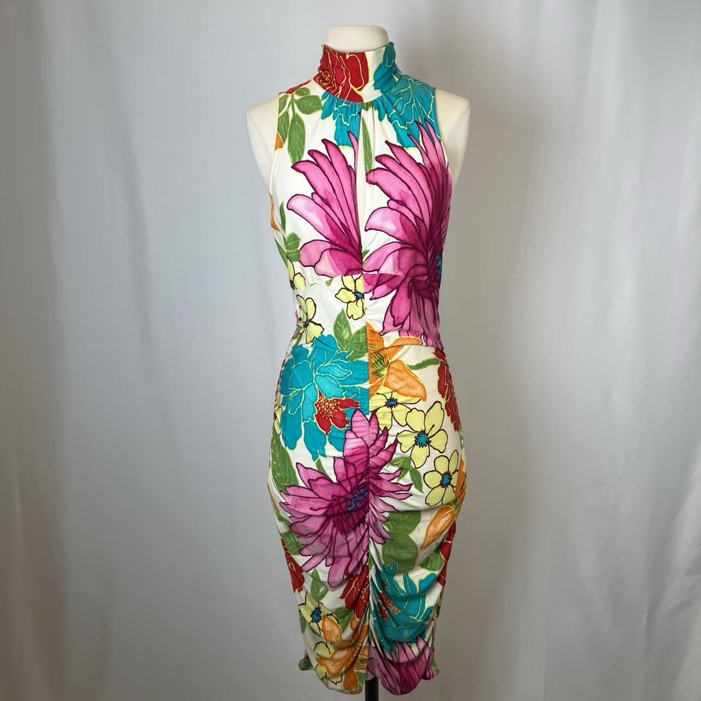 Colorful floral jumpsuit on a mannequin against a plain background