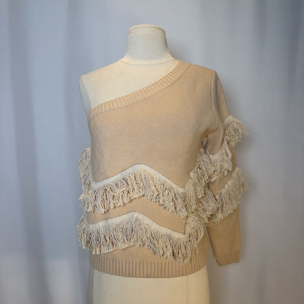 Beige sweater with fringe details on a mannequin against a plain background